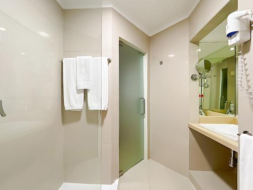 a bathroom with a shower and a sink at Santa Eulalia Hotel & Spa in Albufeira
