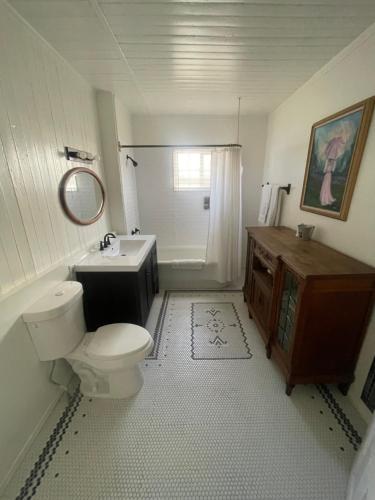 a bathroom with a toilet and a sink at The Bodie Hotel in Bridgeport