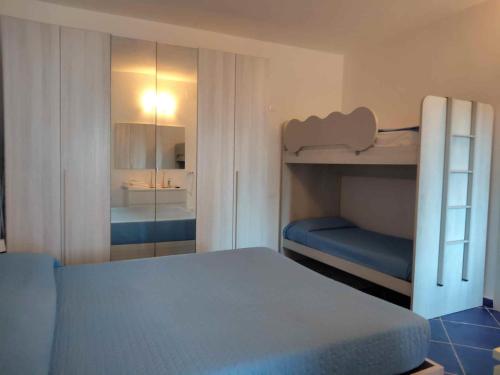 a bedroom with a bunk bed and a mirror at Casa Osvaldo in Marciana