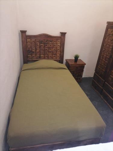 a bedroom with a bed and two night stands at Hostal Queretaro LOMAS M in Laborcillas