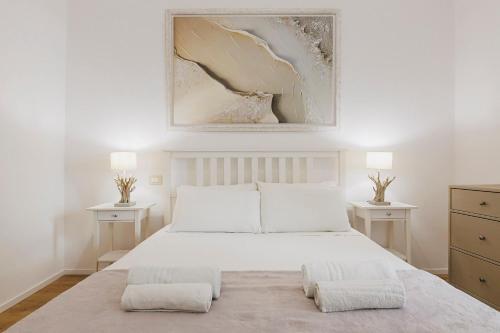 a bedroom with a large white bed with two night stands at Best view Giovinazzo in Giovinazzo