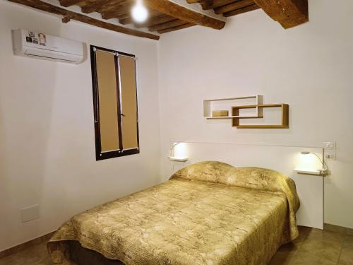 a bedroom with a bed and a window at Roveto Home in Siena