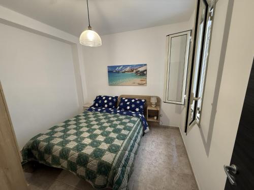 a bedroom with a bed in a small room at Blue Home in Lampedusa
