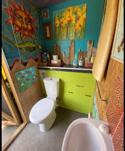 a bathroom with a toilet and a sink at Allys cute Campervan in Carbis Bay