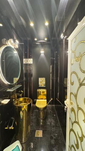a black bathroom with a tub and a sink at كورنيش عجمان in Ajman 
