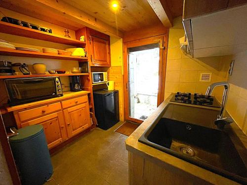 a small kitchen with a sink and a stove at Chalet Maria in Samoëns