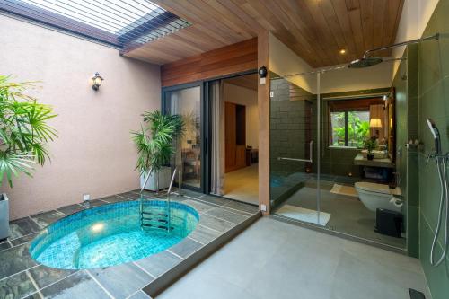 a bathroom with a lap pool and a shower and a toilet at Cascara Resort Weligama - A Tropical Sanctuary in Weligama