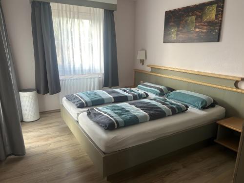 a bedroom with a bed with two pillows on it at Ferienhaus Lechseeidylle in Lechbruck