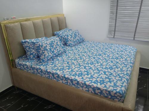 a bed with two pillows on it in a room at Lovely surulere apartment in Lagos