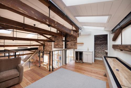 an industrial loft with exposed brick and wood at The Evalina Hotel in Portland