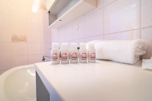 a bathroom with three bottles on a counter next to a sink at Scenic Alps View Getaway in Aquila