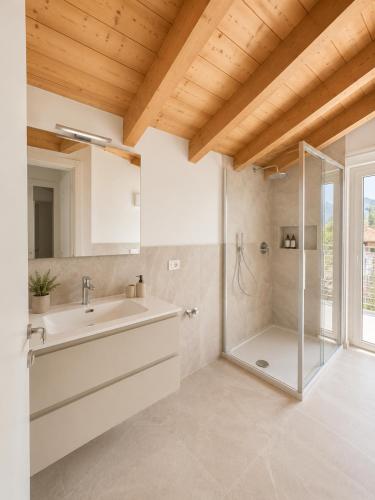 a bathroom with a sink and a shower at Iseo Collection in Riva di Solto