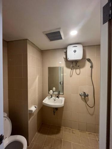 a bathroom with a sink and a toilet at Studio Apartemen Parahyangan Residence by Anton in Bandung