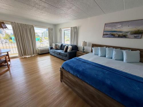 a bedroom with a large bed and a couch at Beachcomber Motel in Ocean City