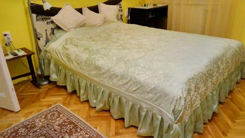 a bedroom with a large bed with pillows on it at Klauzál Apartment in Szeged