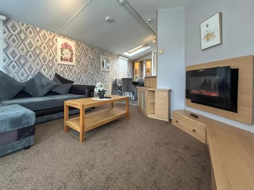 a living room with a couch and a tv at Uk51412 - The Haven in Brechin