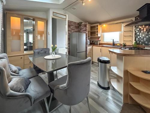 a kitchen with a table and chairs and a refrigerator at Uk51412 - The Haven in Brechin