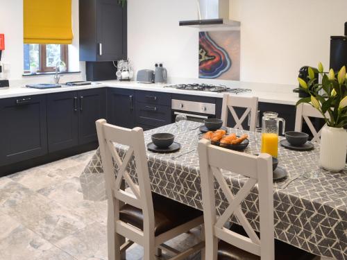 a kitchen with a table with oranges on it at The Alnwick Townhouse in Alnwick