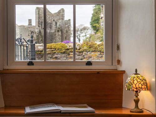 a window in a room with a book and a lamp at Lawson's Studio in Redmire