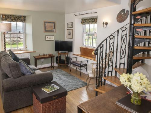 a living room with a couch and a table at Lawson's Studio in Redmire