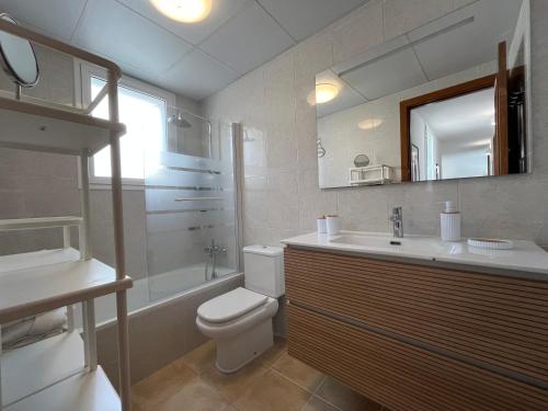 a bathroom with a toilet and a sink and a mirror at Villa Chloe in Punta Grossa
