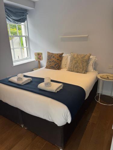 a bedroom with a large bed with towels on it at Wheatsheaf Inn in Brigsteer