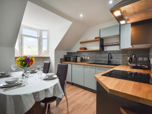 a kitchen with a table with a white table cloth at Tay Views Apartment in Perth