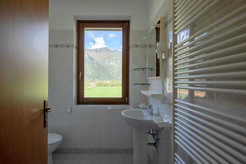 a bathroom with a sink and a window at Hotel Residence La Pertica in Tremosine Sul Garda