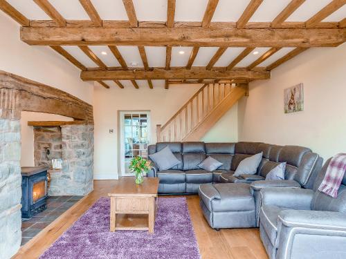 a living room with a couch and a fireplace at Rhiew Banc in Aberhafesp