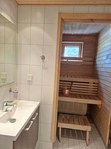 a small bathroom with a sink and a mirror at Yllästar 3 - Cozy Stay in Magical Lapland in Äkäslompolo