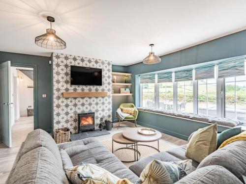 a living room with a couch and a fireplace at Pennant in Llanerfyl
