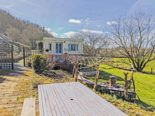 a small house in a field with a wooden deck at Rosie - Uk49025 in Pencarreg