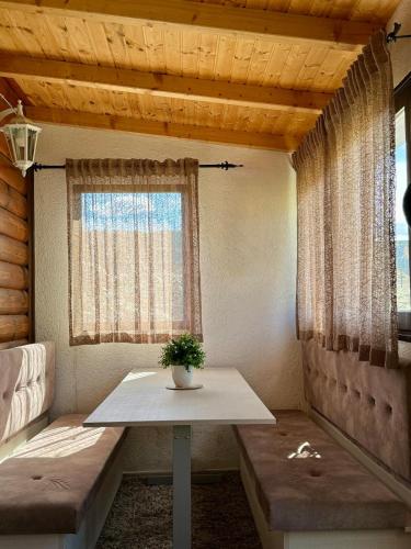 a small room with a table and a window at Vikendica Varde Žabljak in Žabljak