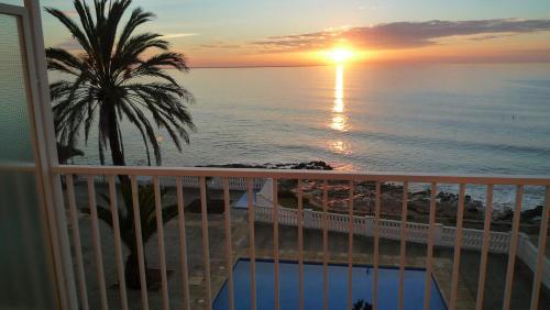 a view of a sunset from a balcony at Carlos III in Sant Carles de la Ràpita