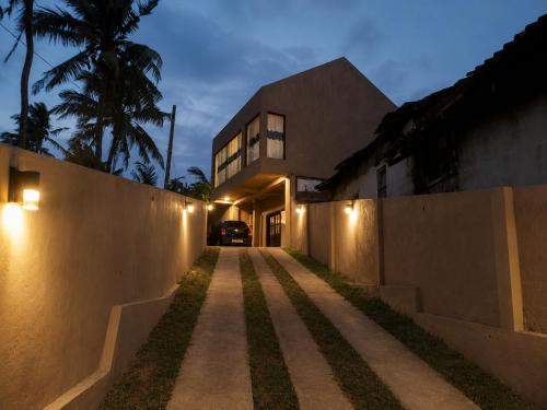 a house with lights on the side of a street at Villa Yuvin in Matara