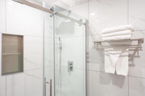 a bathroom with a shower and a glass shower door at Travelodge by Wyndham Langley in Langley