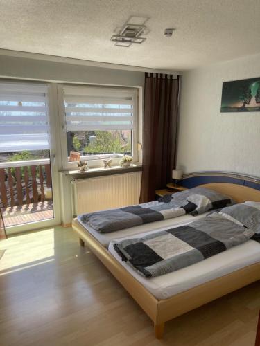 a bedroom with two beds in front of a window at Ferienwohnung Matthias Lang in Rugendorf