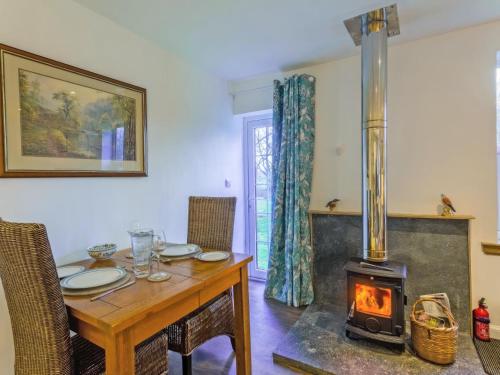 a dining room with a table with a wood stove at The Bungalow in Dingwall