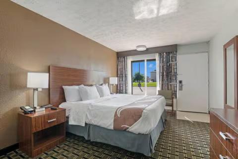 a hotel room with a large bed and a window at The Cherrywood Inn in Georgetown