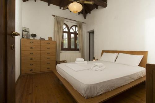 a bedroom with a bed with two towels on it at Villa Thea in Kalogria