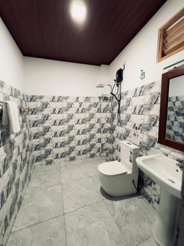 a bathroom with a toilet and a sink at New National in Pettah