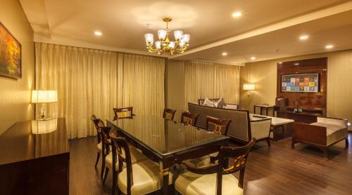 a dining room with a table and chairs at Samanvay Boutique Hotel in Udupi