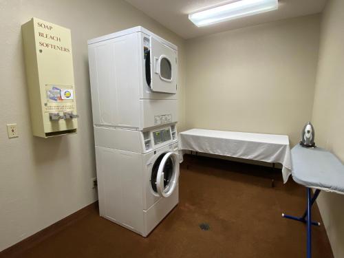 a hospital room with a washing machine and a table at Edmore Inn in Edmore