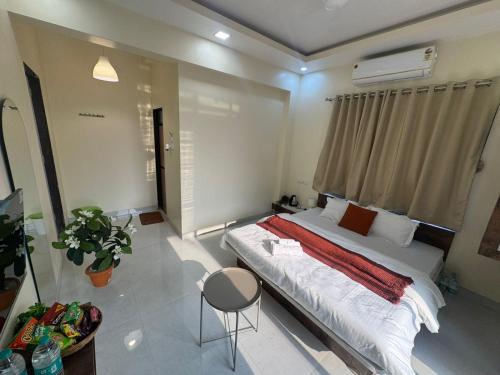 a bedroom with a large bed and a window at The Sora Stay in Alibaug