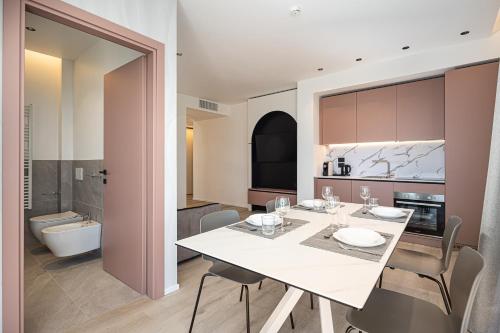 a kitchen with a dining table and a bathroom at Palatium Riccione Suite in Riccione