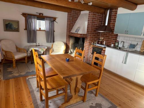 a kitchen and dining room with a wooden table and chairs at Bonäs bygdegård in Mora