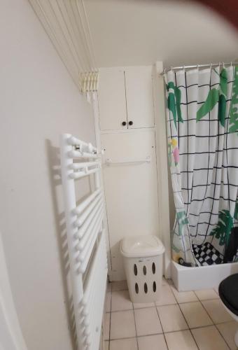 a small room with a white closet and a door at Studio de l'Armançon in Semur-en-Auxois