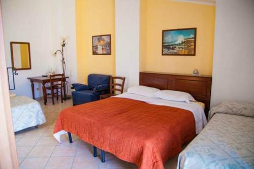a hotel room with a bed and a chair at Bed & Breakfast Il Castellino in Santo Stefano di Camastra