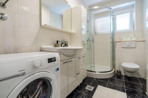 a bathroom with a washing machine and a sink at Bella Vita in Korčula