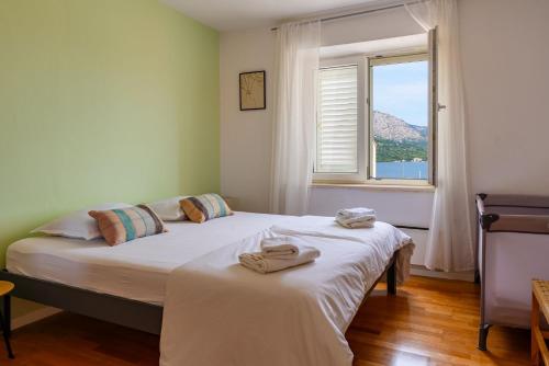 a bedroom with a bed with towels on it at Bella Vita in Korčula